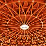 L�elemento che spettacolarizza il tutto � il soffitto: un enorme disco in legno, fatto di aste che creano un gioco di triangoli che si rincorrono in cerchi concentrici